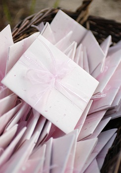 invitations to a bridal shower wrapped in pink ribbon