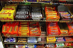 variety of candy bars on a shelf in a store