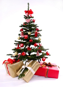 Christmas tree with presents ornaments and three gifts underneath wrapped in gold and red foil paper