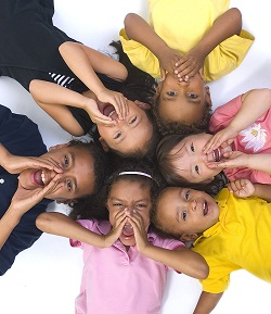 kids laying on the floor in a circle pretending to shout and have a good time playing kids games