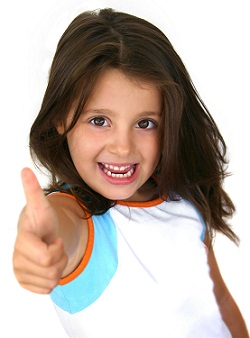 young girl smiling with a big thumbs up sign