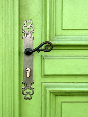 fancy doorknob on a neon green door