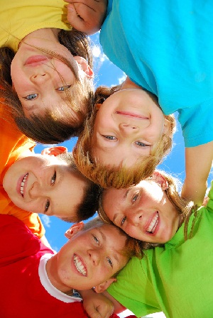 childrens happy faces wearing bright shirts